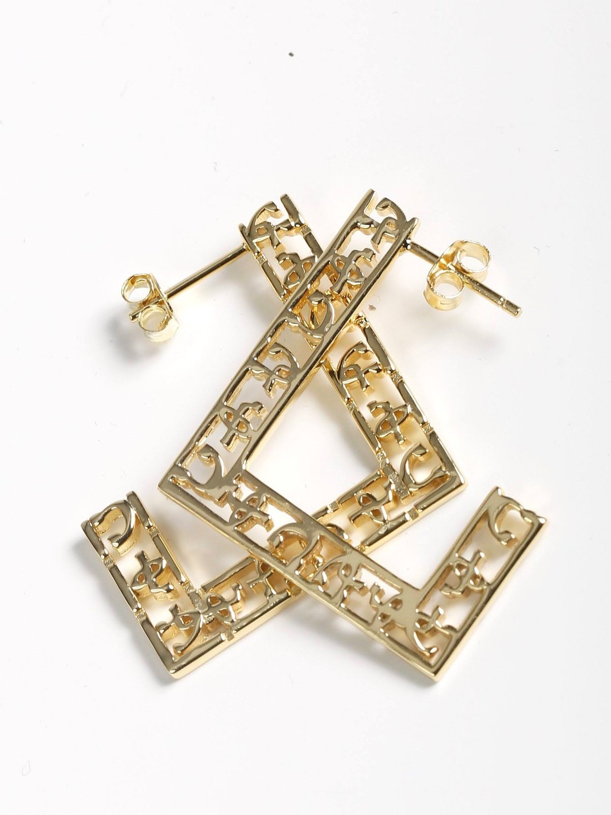 Hawi Yema Issey earrings in 14k gold-plated sterling silver featuring carved fikir (love) motif in semi-square shape