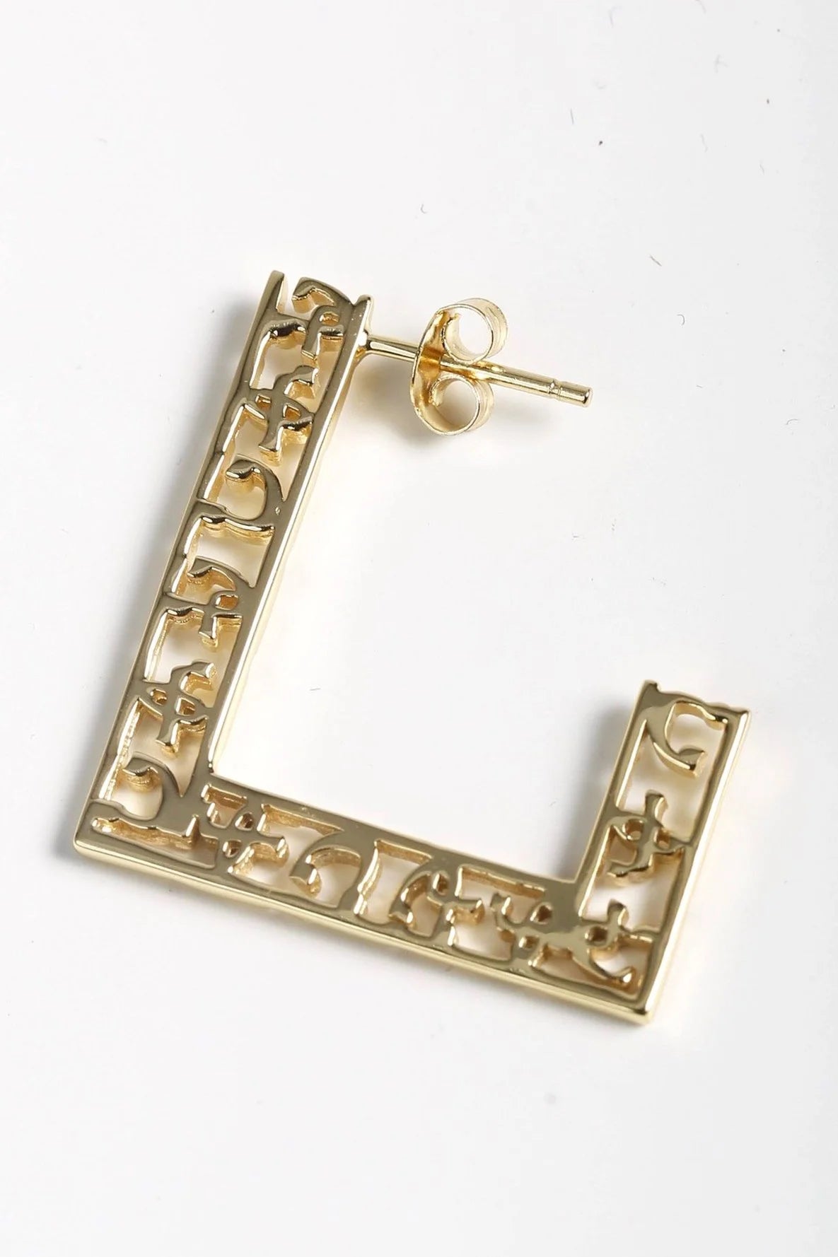 Hawi Yema luxury earrings displaying carved love motif in contemporary semi-square design