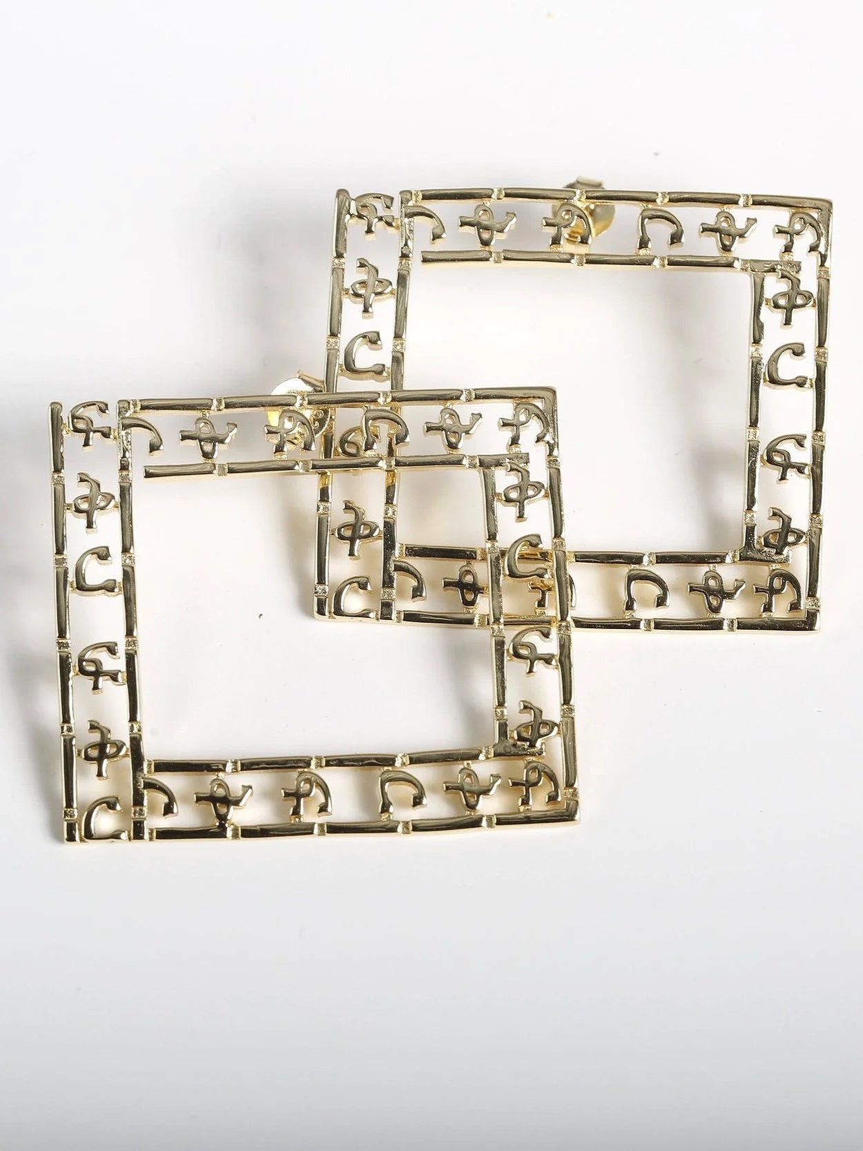 Hawi Yema Karē statement earrings in 14k gold-plated sterling silver with carved Amharic letters in bold square shape