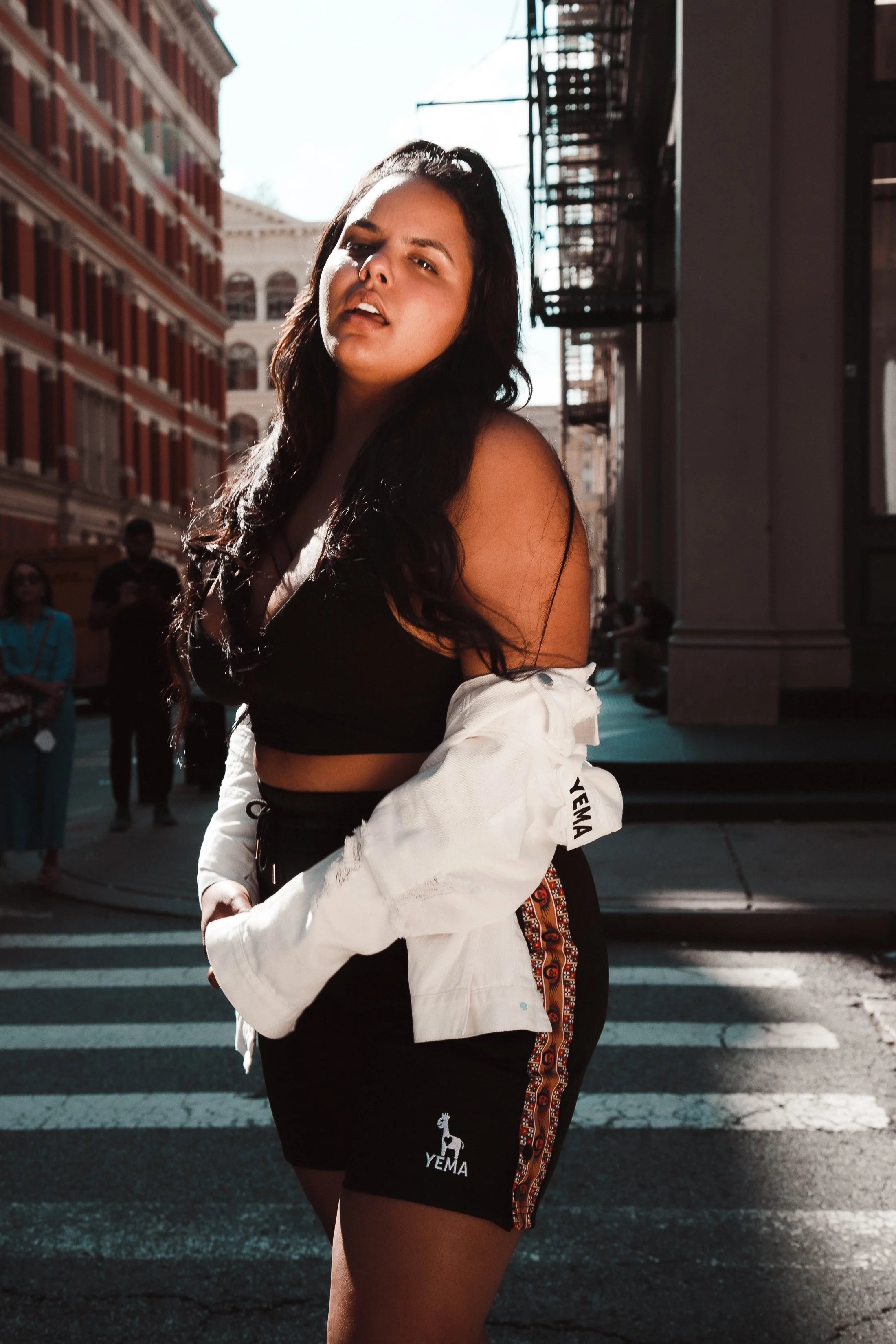 YEMA track shorts with Ethiopian heritage angels motif and sporty performance fit