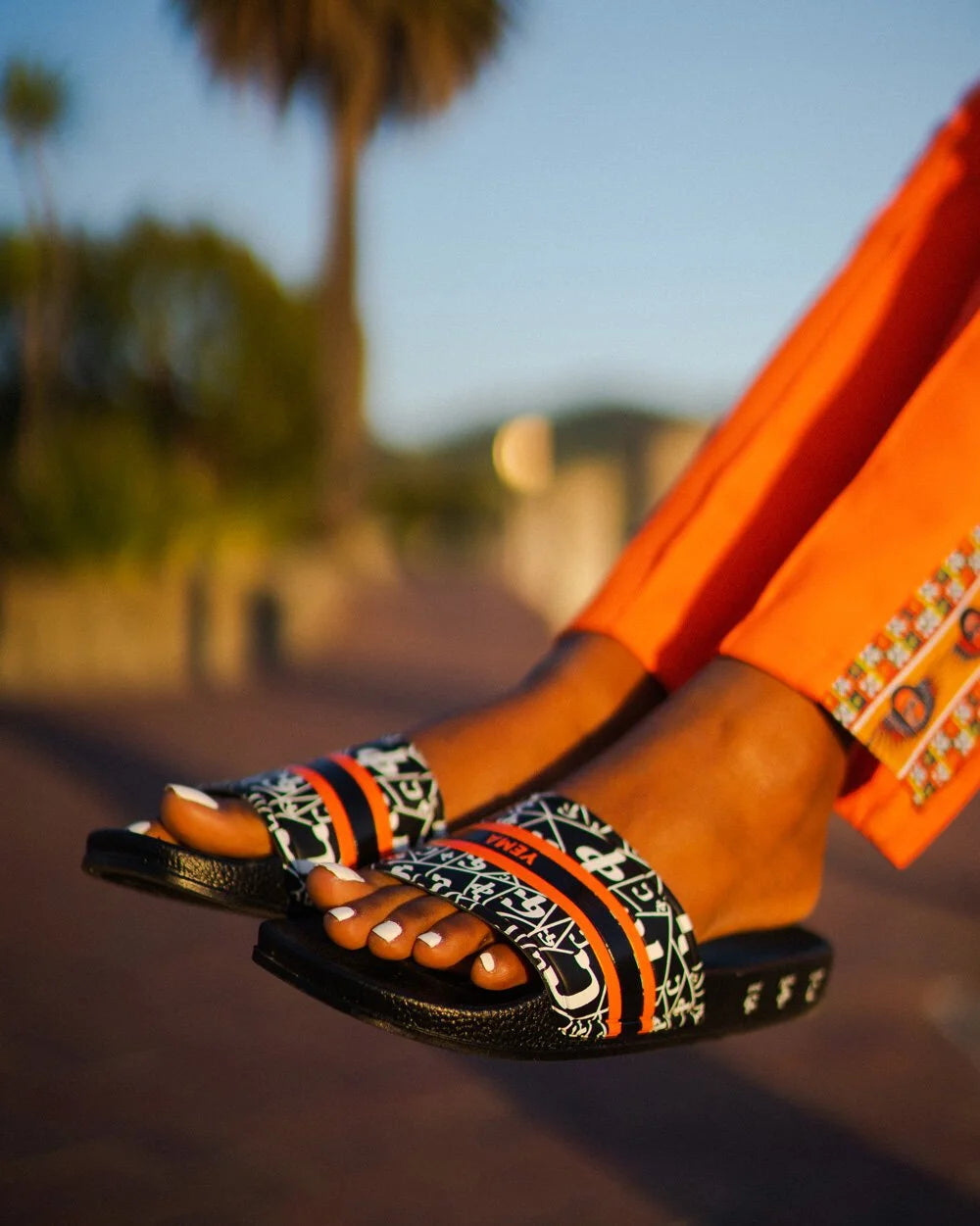 Side angle of quick-dry polyurethane slides with rubber outsole and cultural Amharic design