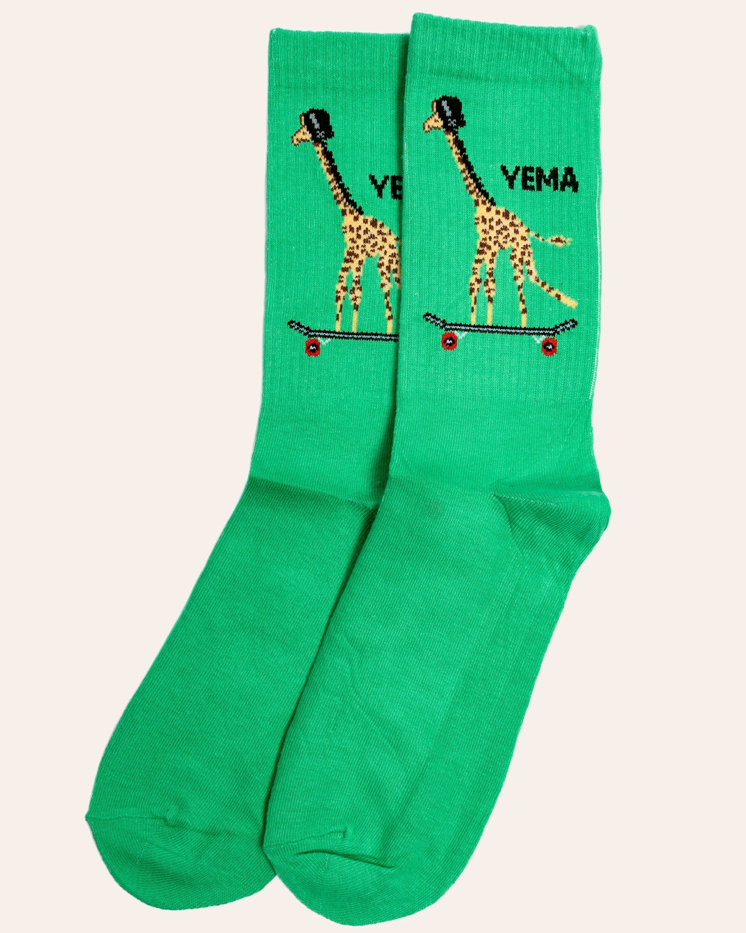 YEMA giraffe skating socks in Kibera Green with iconic giraffe on skateboard graphic