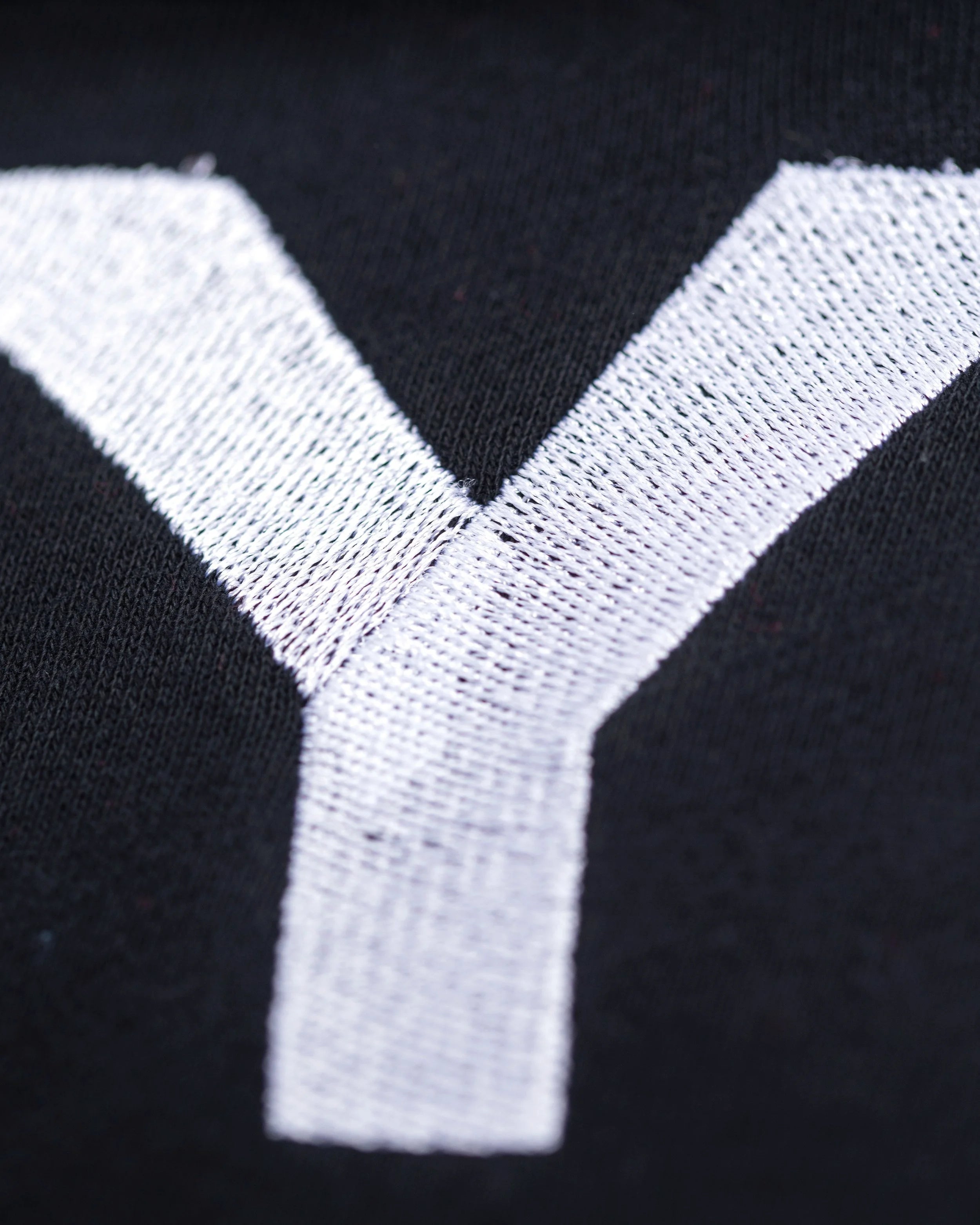 Close-up of Good Joyful Human hoodie with skating giraffe and YEMA sleeve accent in black