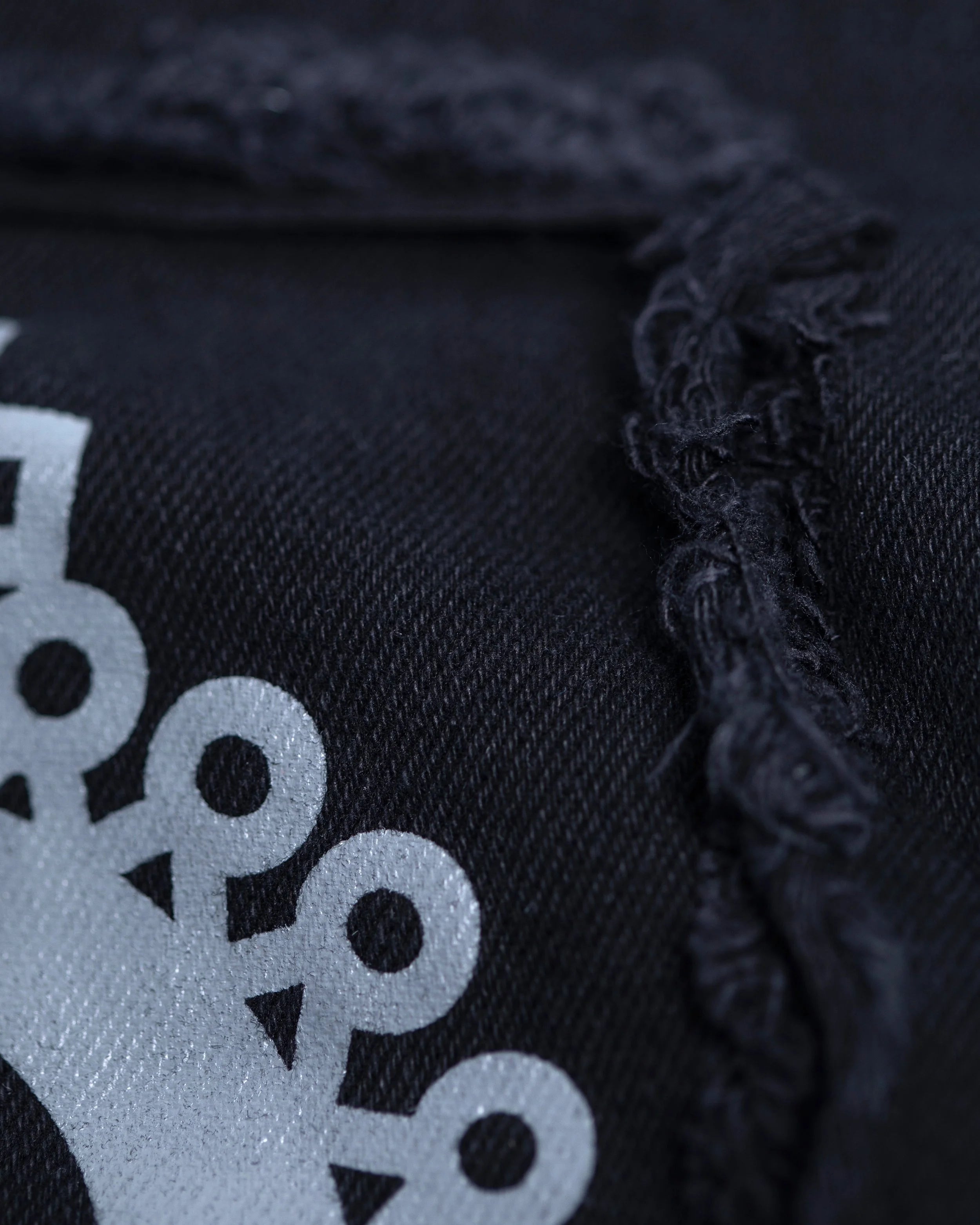 Detail shot of Ethiopian motifs on YEMA GJH joggers in Addis Black