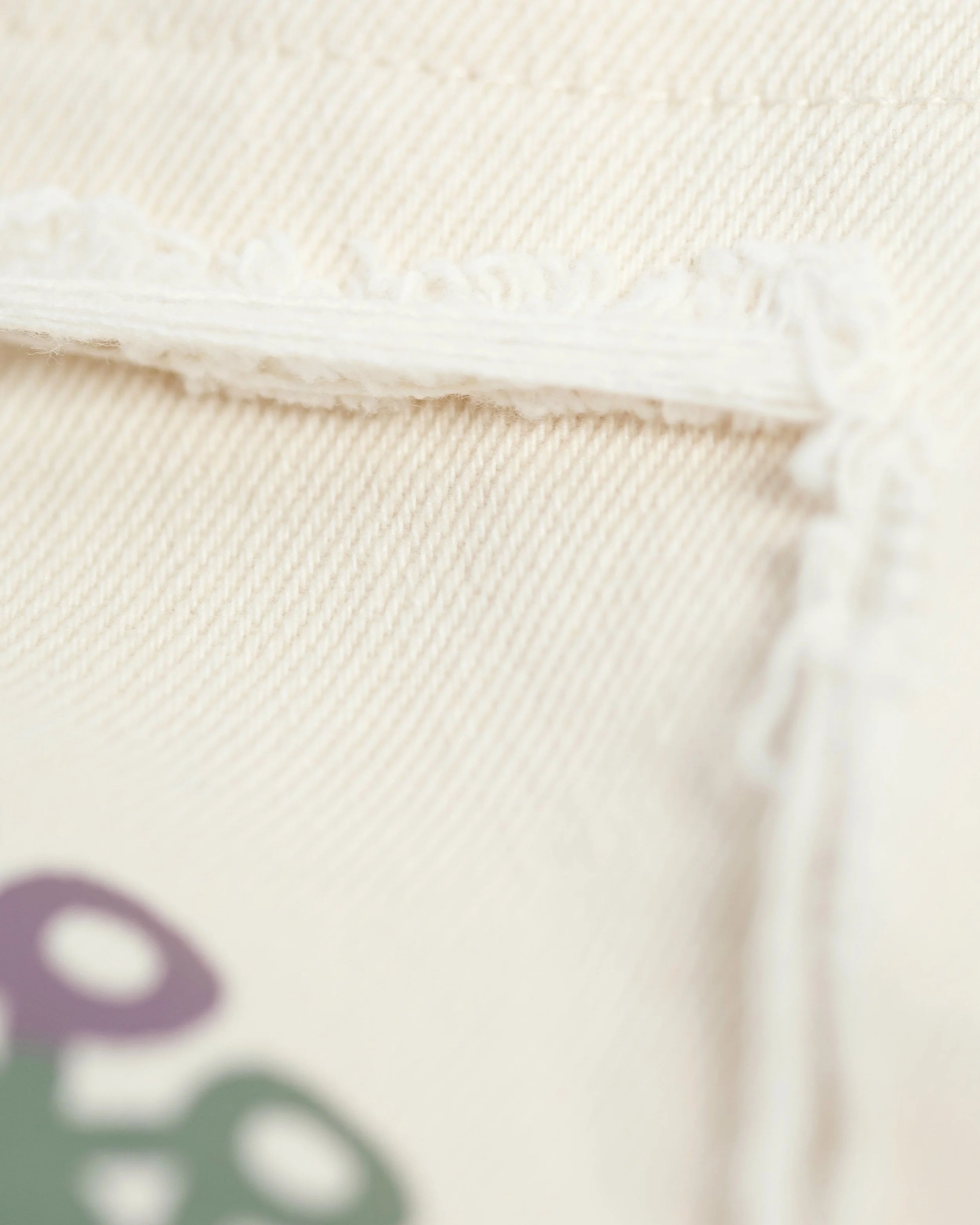 Detail of YEMA joggers displaying distressed aesthetic and flexible stretch fabric in Lalibela colorway
