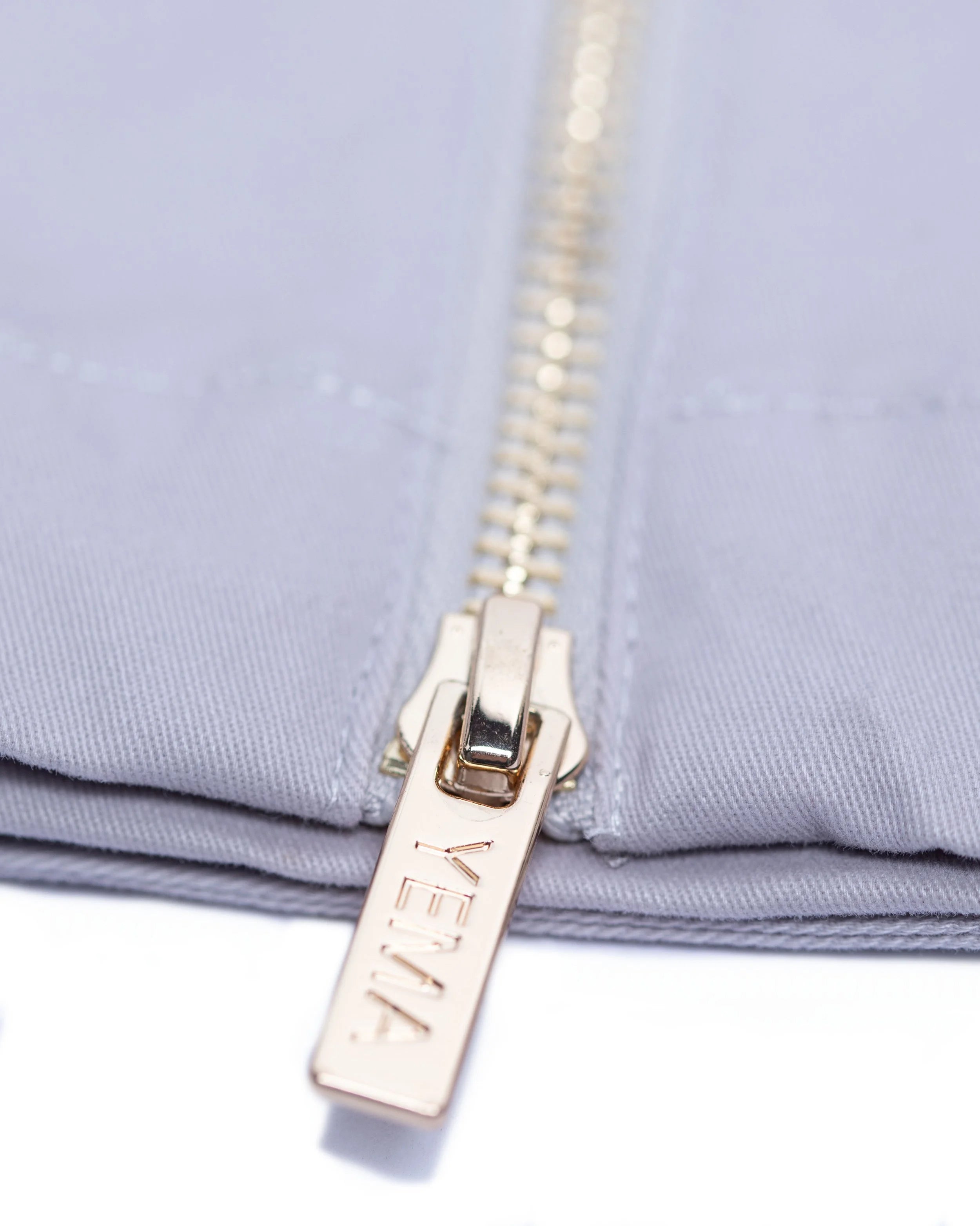 YEMA clay jumpsuit with custom YEMA zipper on sleeve