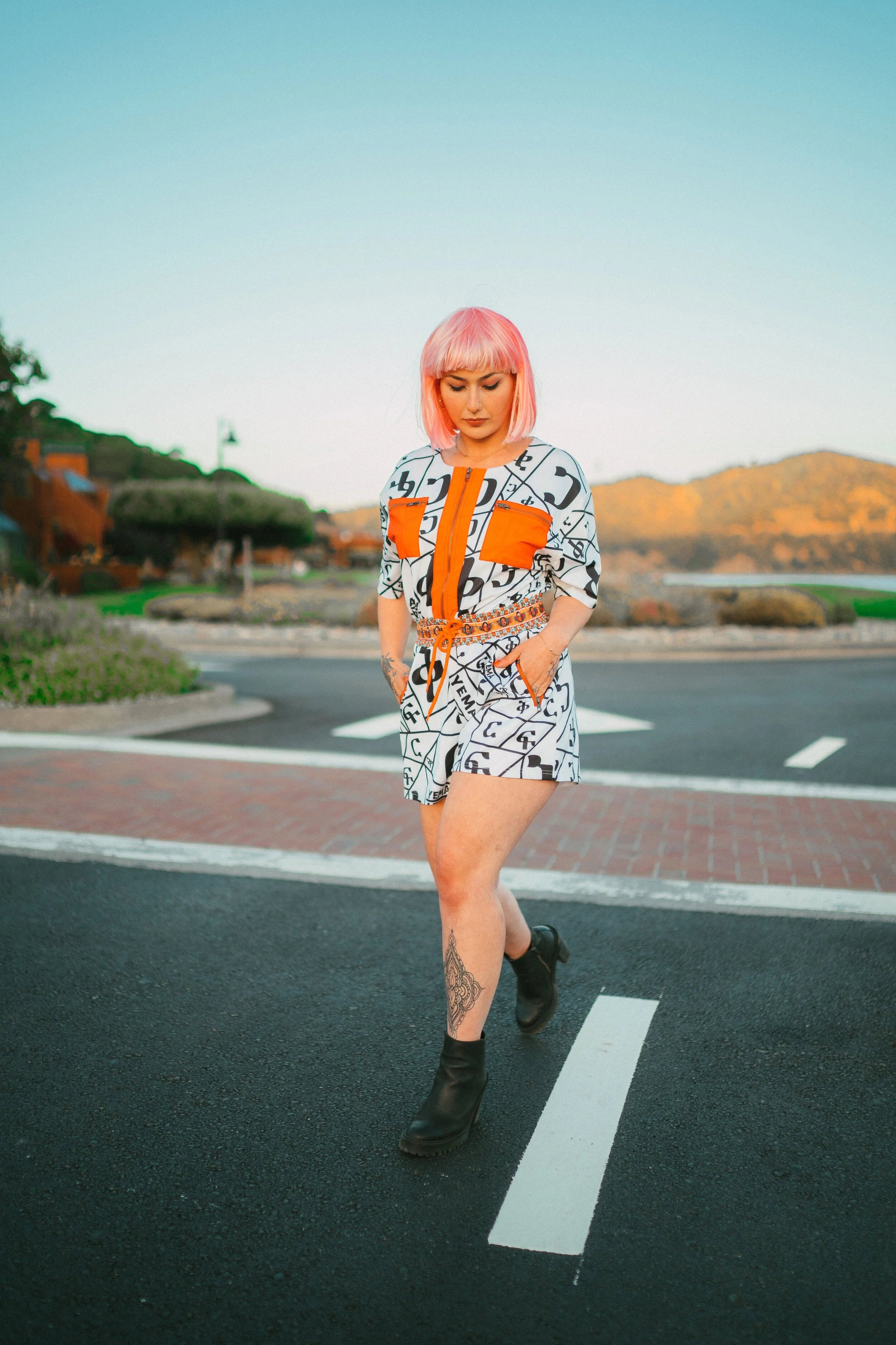 YEMA Hawi Fikir romper with 17th-century Abyssinian angel waist motifs and orange chest pockets