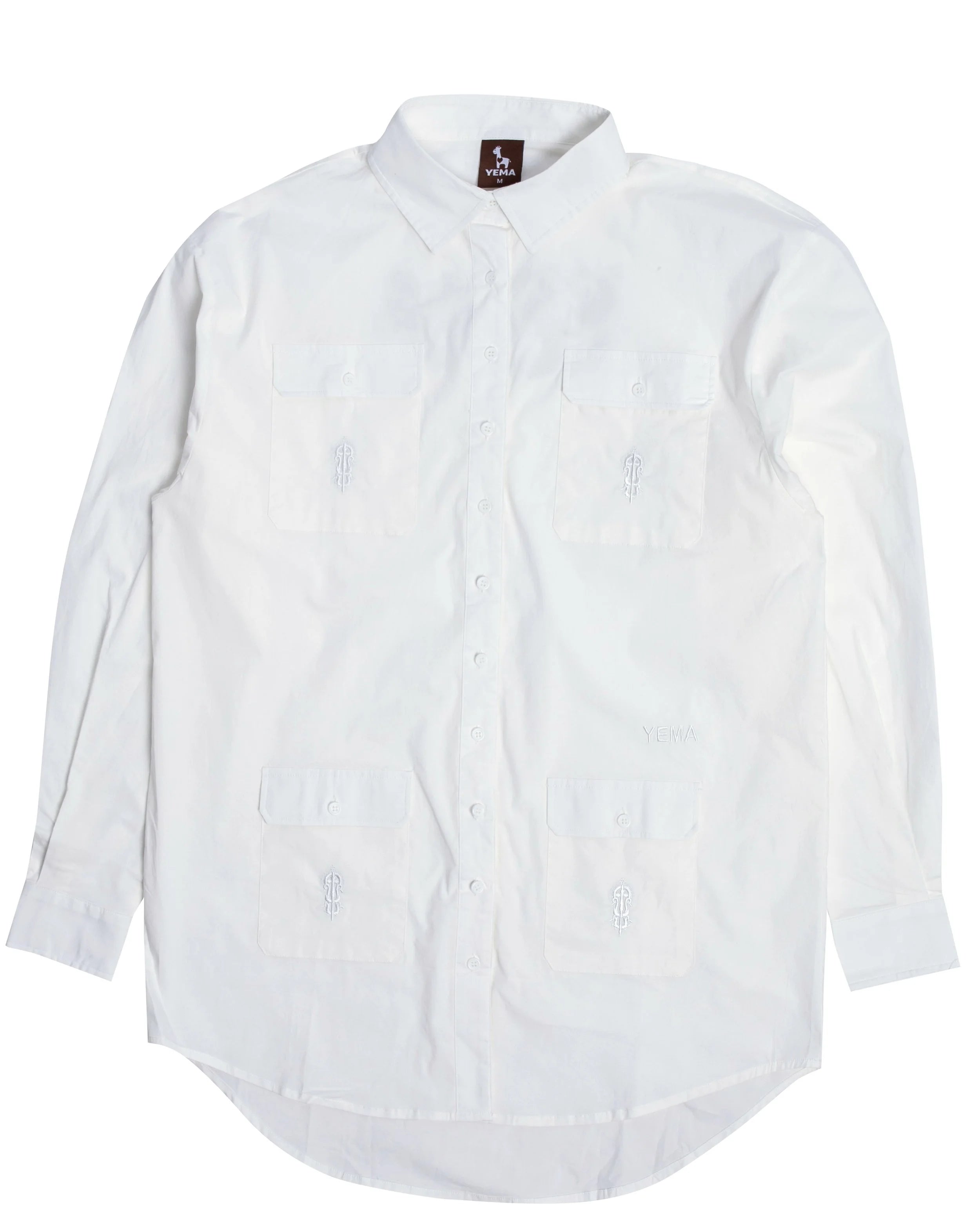 Front view of cotton poplin shirt dress showing iconic meskel embroidery on functional pockets