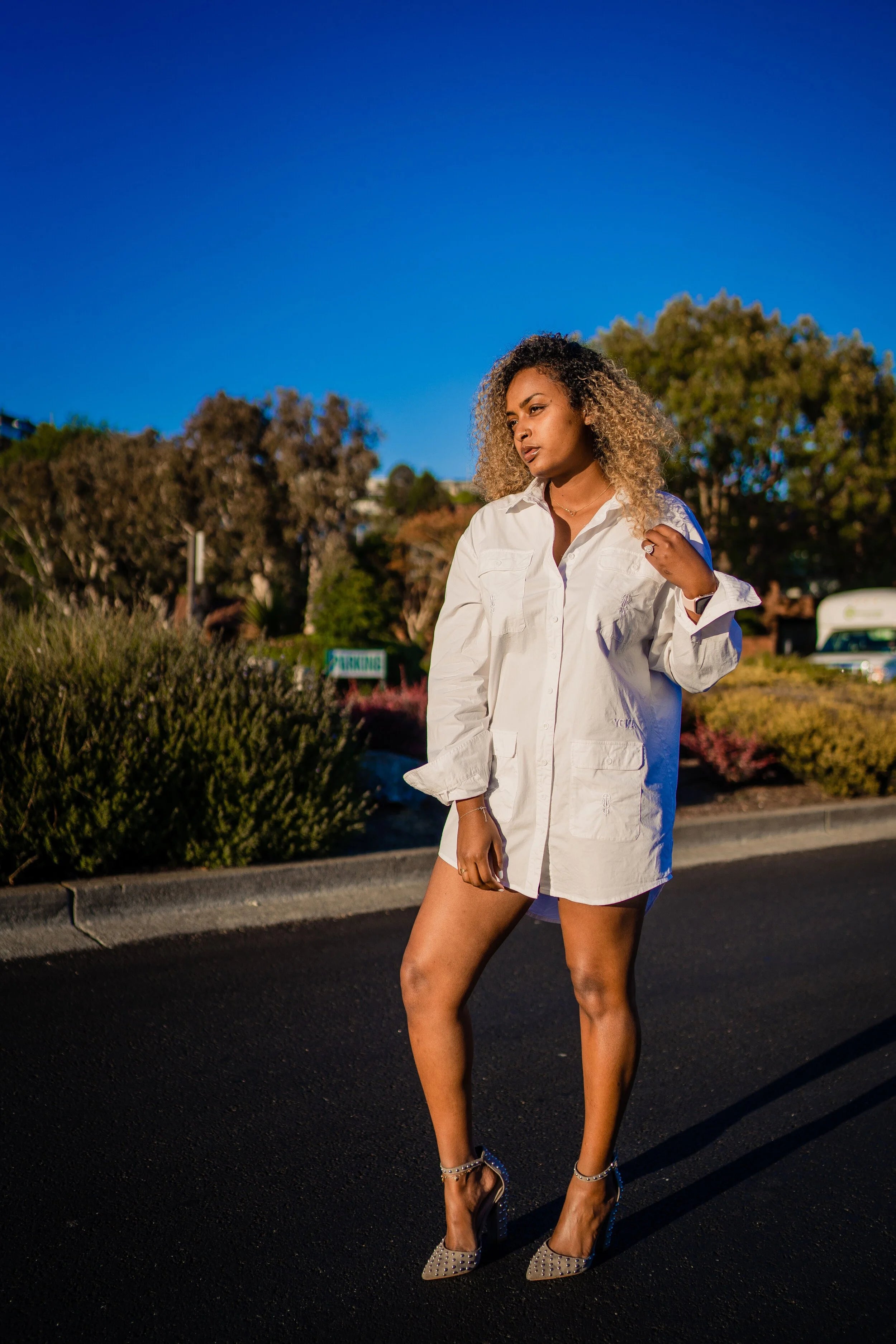 Front view of cotton poplin shirt dress showing iconic meskel embroidery on functional pockets
