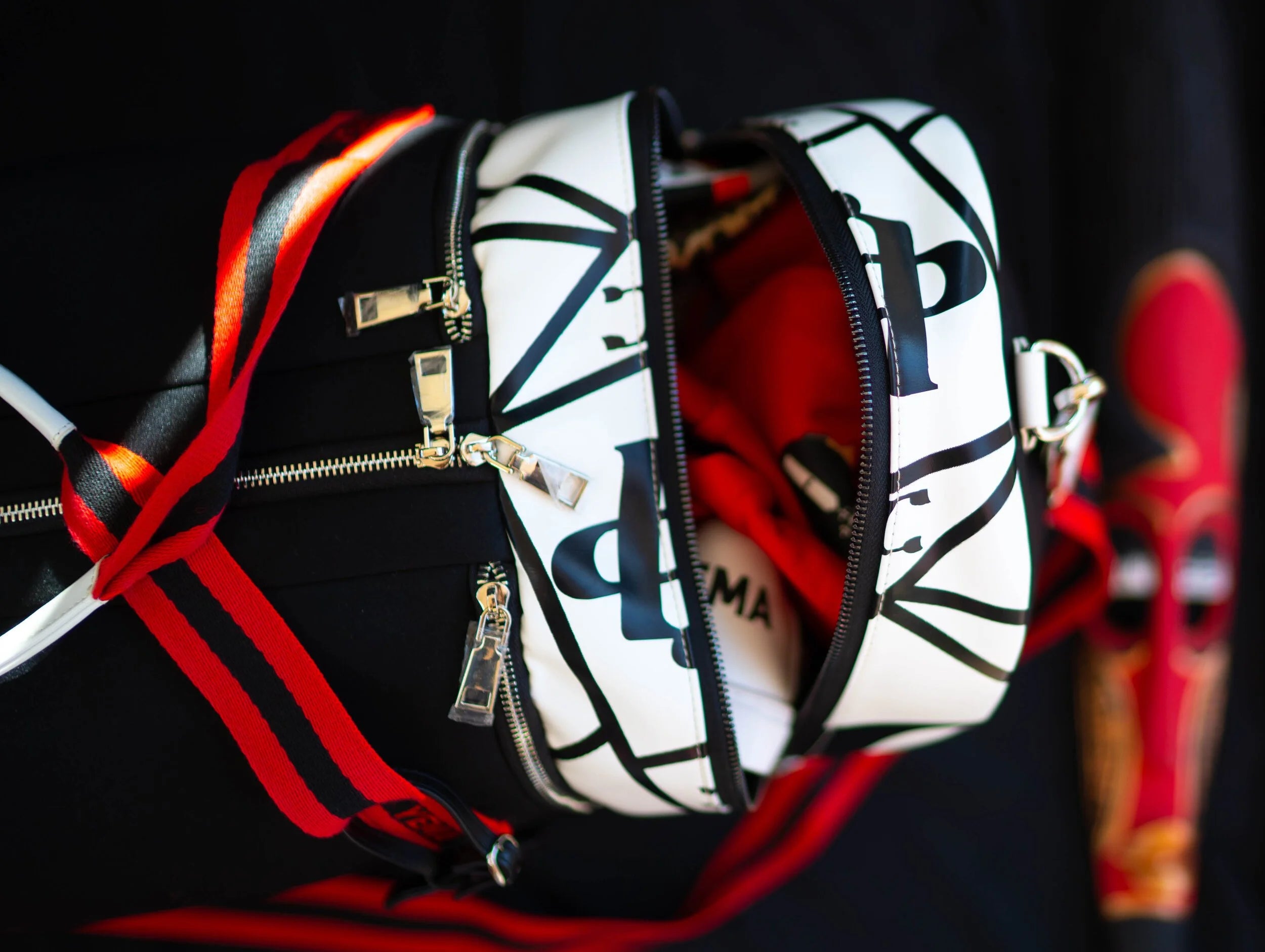 Detail shot of detachable shoulder strap and leather key holder on luxury travel duffle