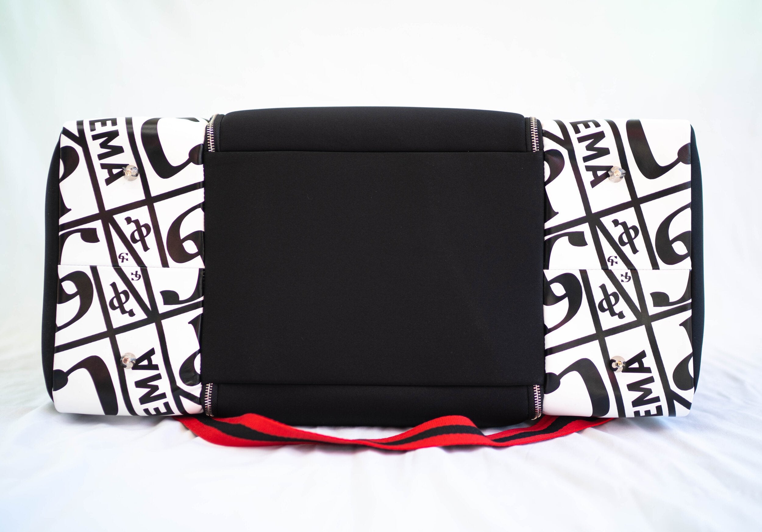 YEMA HY Lux Carry-On Duffle in black neoprene with Amharic-lettered leather accents and mixed hardware
