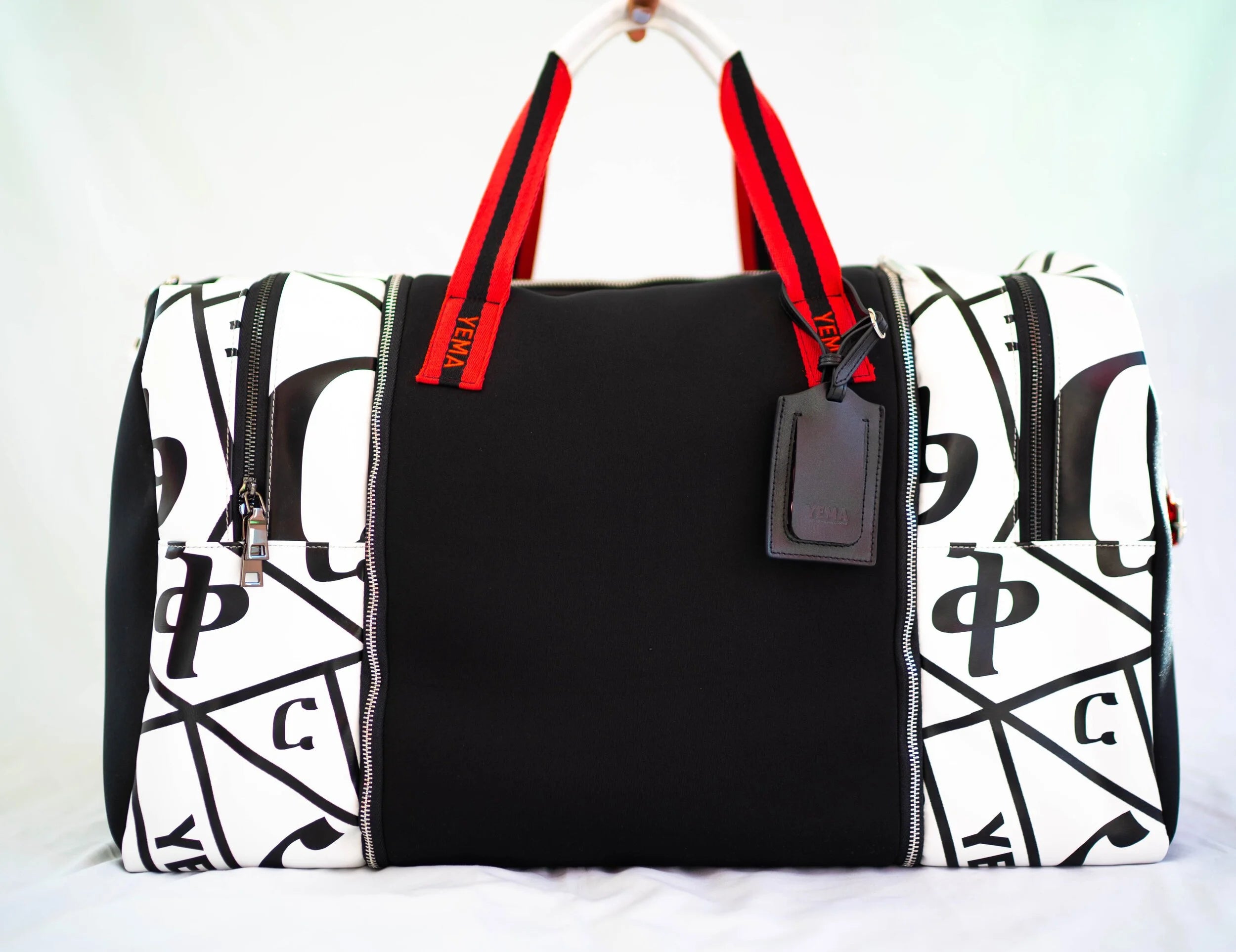 YEMA HY Lux Carry-On Duffle in black neoprene with Amharic-lettered leather accents and mixed hardware