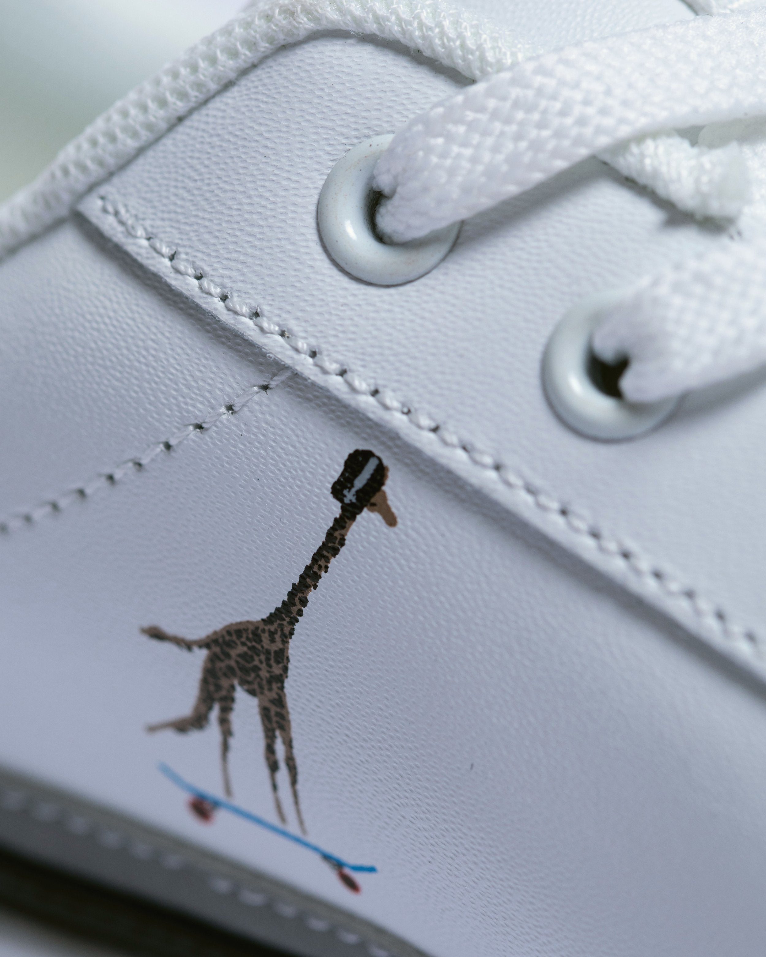 Detail of genuine leather construction with padded collar and comfortable insoles in classic white