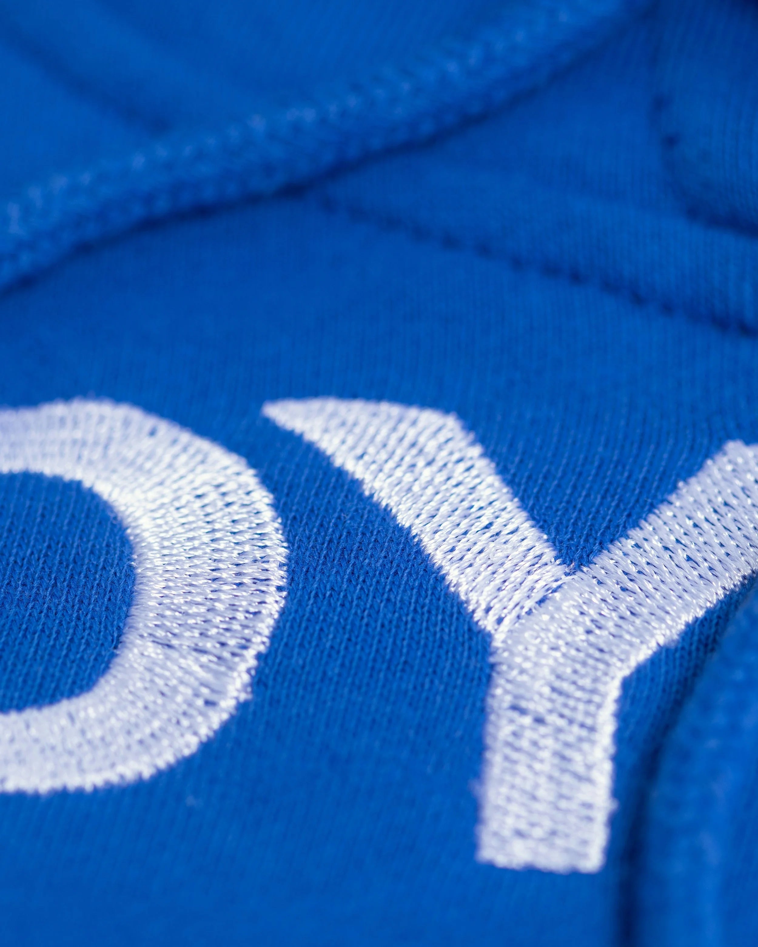 Close-up of Good Joyful Human hoodie with skating giraffe and YEMA sleeve accent