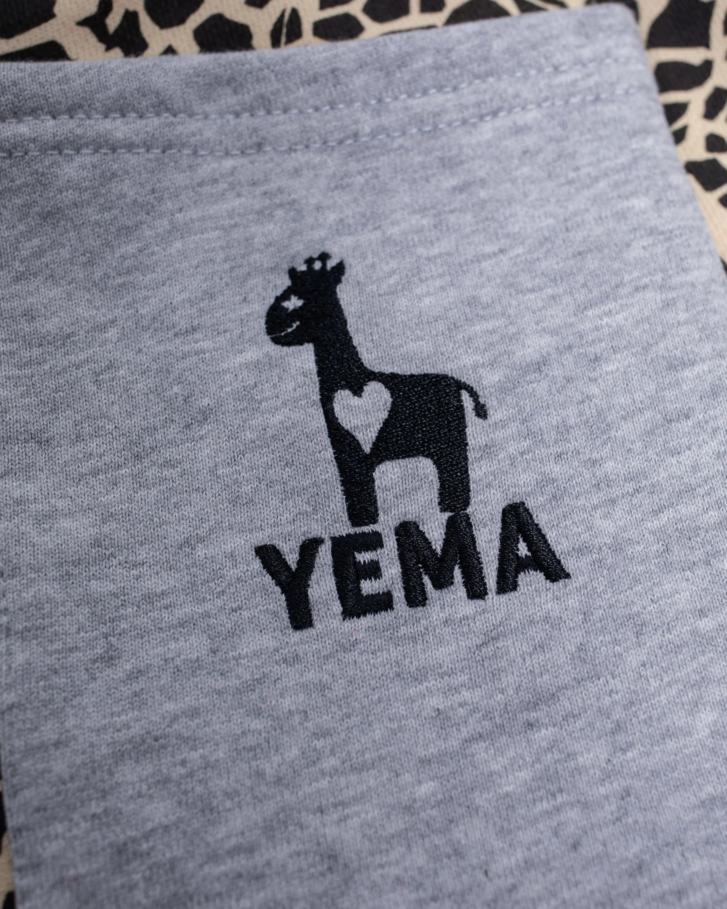 Close-up of Yema logo