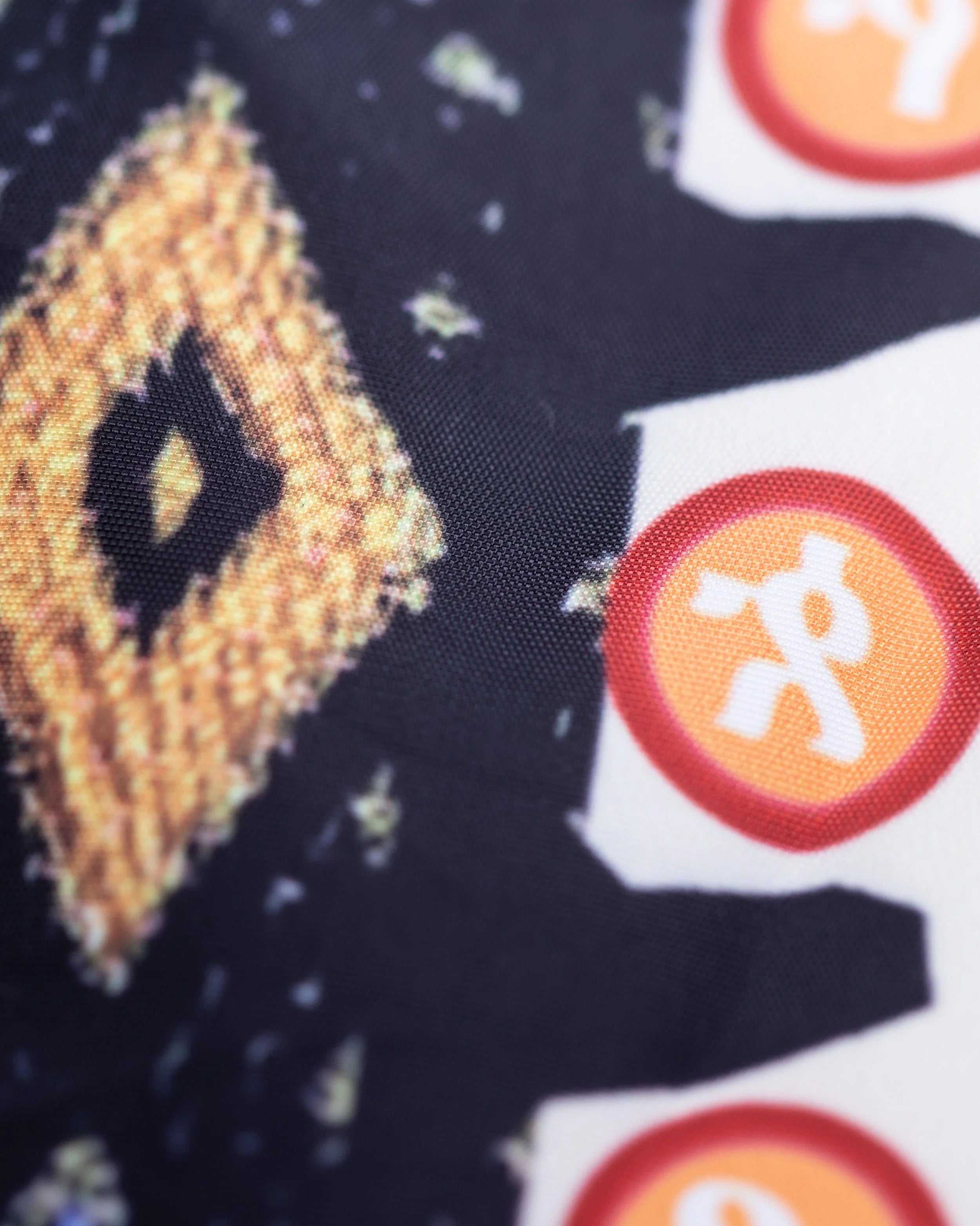 Detail shot of Meskel cross embroidery on YEMA waterproof parka jacket